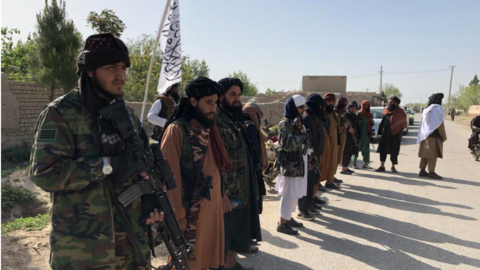 Taliban fighters by a checkpoint