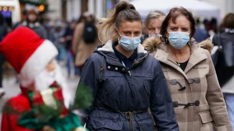 Christmas shoppers wearing masks