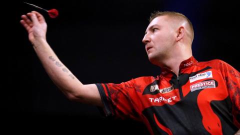 Nathan Aspinall throws a dart