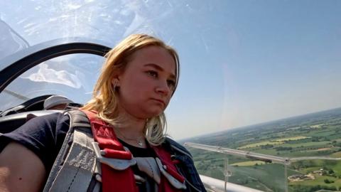 Glider pilot Sienna in the cockpit of a glider in flight