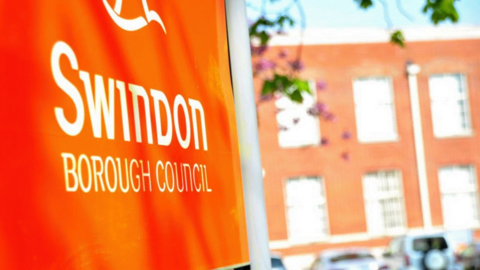 An orange sign outside Swindon Borough Council's office