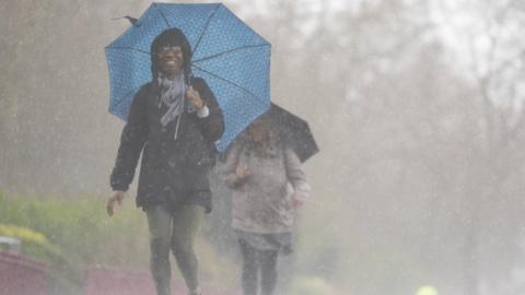 People brave the rainy conditions in Battersea Park, London, on Easter Monday, after a warm spell of weather earlier over the Easter weekend has come to an end.