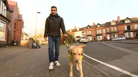 Saleh Ahmed and his guide dog John