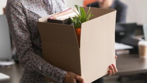 Woman holding box of belongings