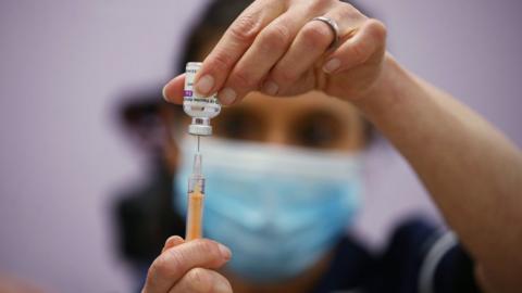 Nurse preparing a Covid-19 vaccine dose