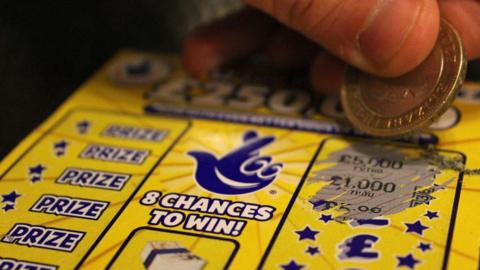 National Lottery scratchcard being scratched off