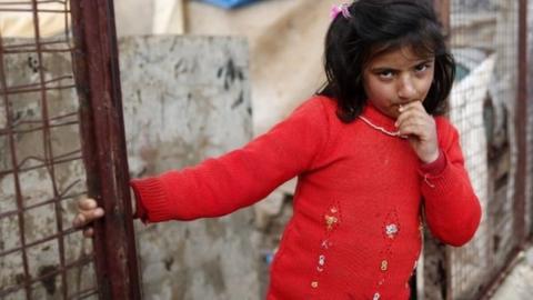 A Syrian refugee girl stands in front of a refugee camp in Bab Al-Salama city, northern Syria, 06 February 2016