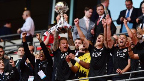 Bromley players celebrate with the FA Trophy