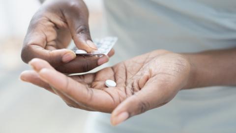 Hand holding pills