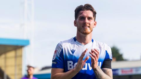 Connor Mahoney celebrates Gillingham's win over Morecambe