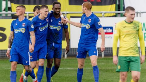 Penybont players congratulate Nathan Wood after his goal at Caernarfon