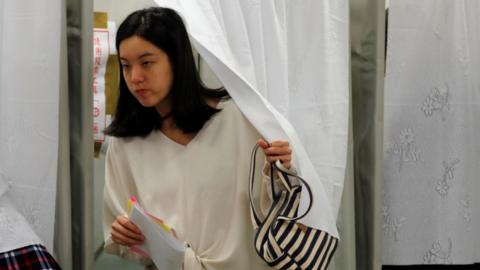 Woman leaves a polling booth after casting her vote in New Taipei City, 11 January 2020