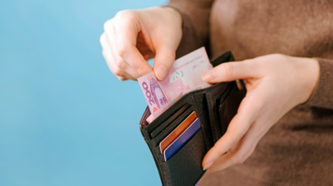 Woman with hryvnia in wallet