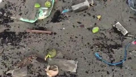 The beach strewn with medical waste