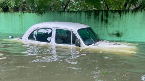 A half submerged car in the Indian city of Chennai this month after Cyclone Michaung brought heavy rain