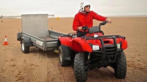 Lifeguarding riding a quad bike