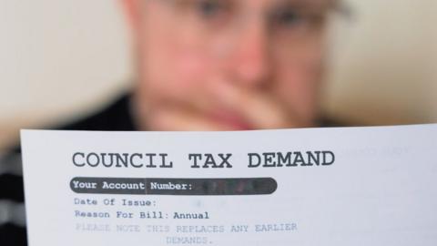 A man looking at his council tax bill