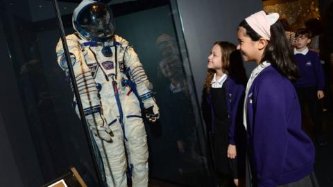 children from Ysgol Glan Morfa, Cardiff, looking at Tim Peake's space suit