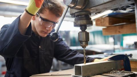 Apprentice using drill