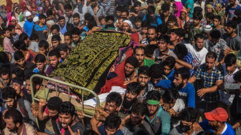 Kashmiri Muslims carry the body of a militants killed in a brief gunfight with Indian armed forces