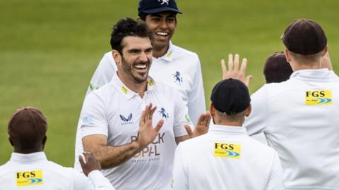 Grant Stewart (second left) celebrates taking a wicket for Kent