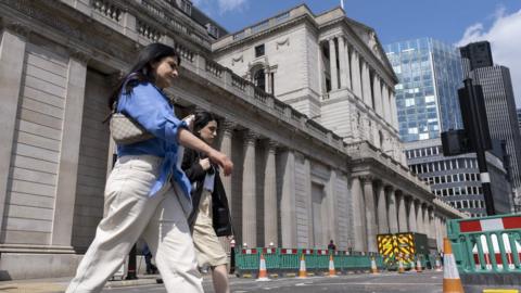 People walking outside Bank of England