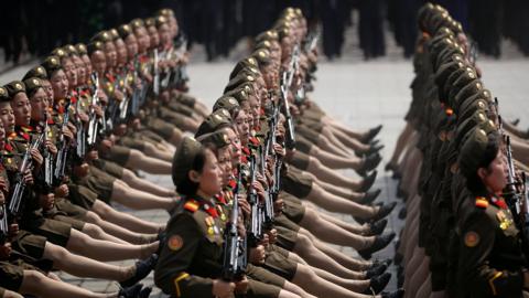 Female soldiers goose-stepping with perfect precision