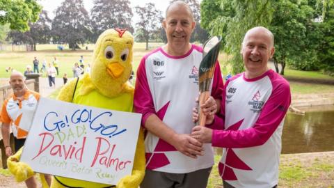 David Palmer and Paul Laffey take part in The Queen's Baton Relay as it visits Uttoxeter as part of the Birmingham 2022 Queens Baton Relay on July 20, 2022 in Uttoxeter