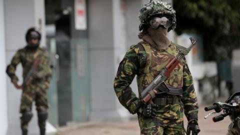 Sri Lankan Special Task Force soldiers stand guard in front of a mosque during the Friday prayers at a mosque