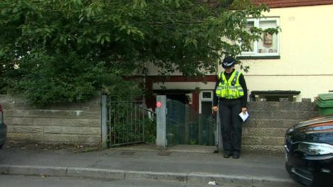 Police officer outside property