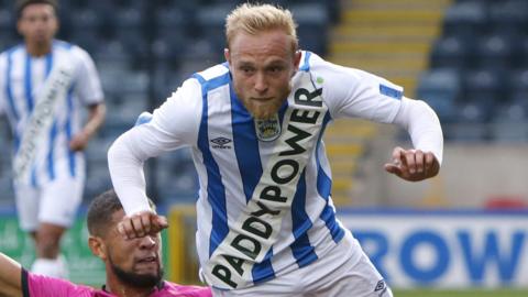 Alex Pritchard wears Huddersfield's controversial spoof kit