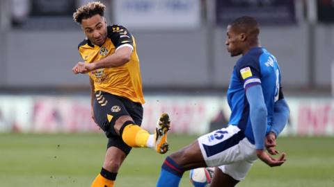 Nicky Maynard of Newport County has his shot at goal blocked by Aaron Hayden of Carlisle United