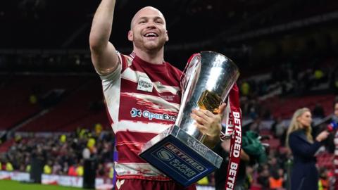 Wigan winger Liam Marshall with the Super League trophy