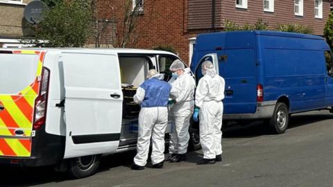 Forensic officers at crime scene in Downley