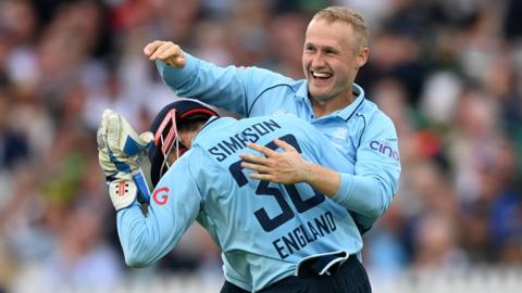 Matt Parkinson and John Simpson celebrate taking a wicket