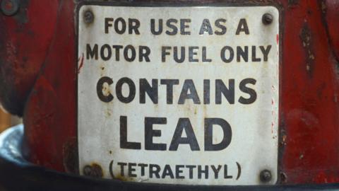 Vintage petrol pump in Nashville, Tennessee, with a sign saying that the petrol contains lead