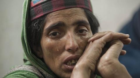 A woman at the relief camp is seen crying.