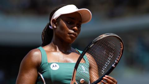 Sloane Stephens looks at her racquet