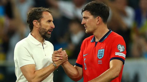 Harry Maguire pictured with England boss Gareth Southgate after a Euro 2024 qualifier against Ukraine