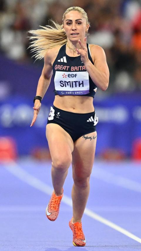 Para-athlete Ali Smith in a black running outfit on a track