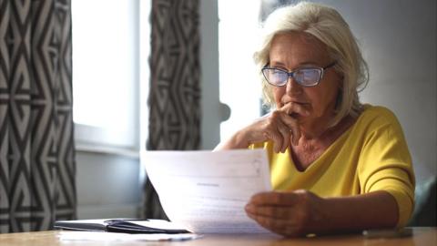Pensioner looking at bills