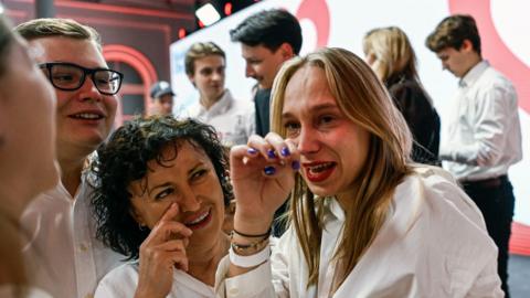 Supporters of the leader of Civic Coalition (KO), Donald Tusk celebrate the exit poll results during Poland's Parliamentary elections on October 15, 2023 in Warsaw, Poland