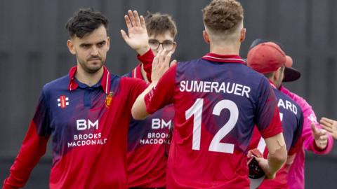 Jersey cricket team celebrate taking a wicket