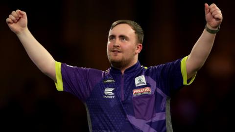 Luke Littler celebrates beating Rob Cross in the PDC World Darts Championship semi-final