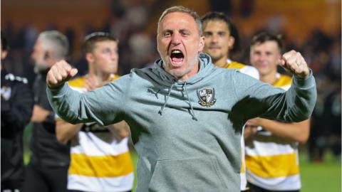Port Vale manager Andy Crosby celebrates after his side win on penalties in the Carabao Cup