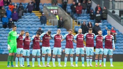 Burnley players standing in a line on the pitch