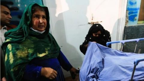 Relatives stand near the body of one of three female media workers who were shot and killed by unknown gunmen, at a hospital in Jalalabad, Afghanistan March 2, 2021.