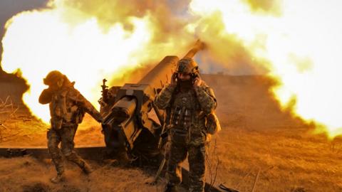 Ukrainian servicemen fire with a howitzer at Russian positions near Bakhmut, eastern Ukraine