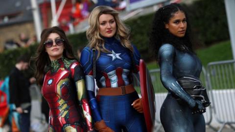 Cosplayers dressed as Iron Man, Captain America and Black Panther
