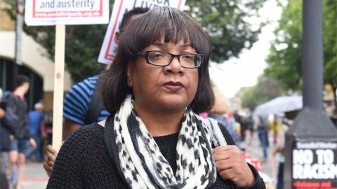 Diane Abbott arrives at a protest at Stoke Newington police station over the death of Rashan Charles